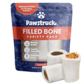 Pawstruck filled bone variety pack dog treats in blue and orange packaging with three white bones displayed, showing different flavored fillings inside.