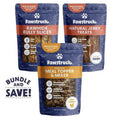 Three packages of Pawstruck dog treats with labels for Rawhide Bully Slices, Natural Jerky Treats, and Meal Topper & Mixer on a white background.